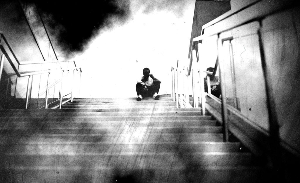 Young man sitting at the top of some stairs